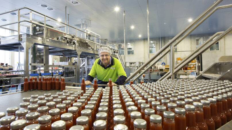 PLENTY OF PRODUCTS: Beerenberg Family Farm managing director Anthony Paech inspects some tomato sauce at the new facility.