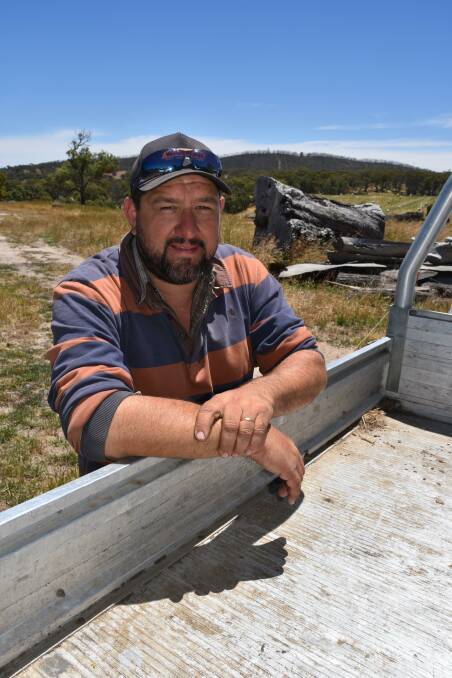 CONSTANT BATTLE: Dairyfarmer Michael Kowald - with a blackened Mount Torrens in the background - says keeping up with vegetation growth has been a hard task this year.