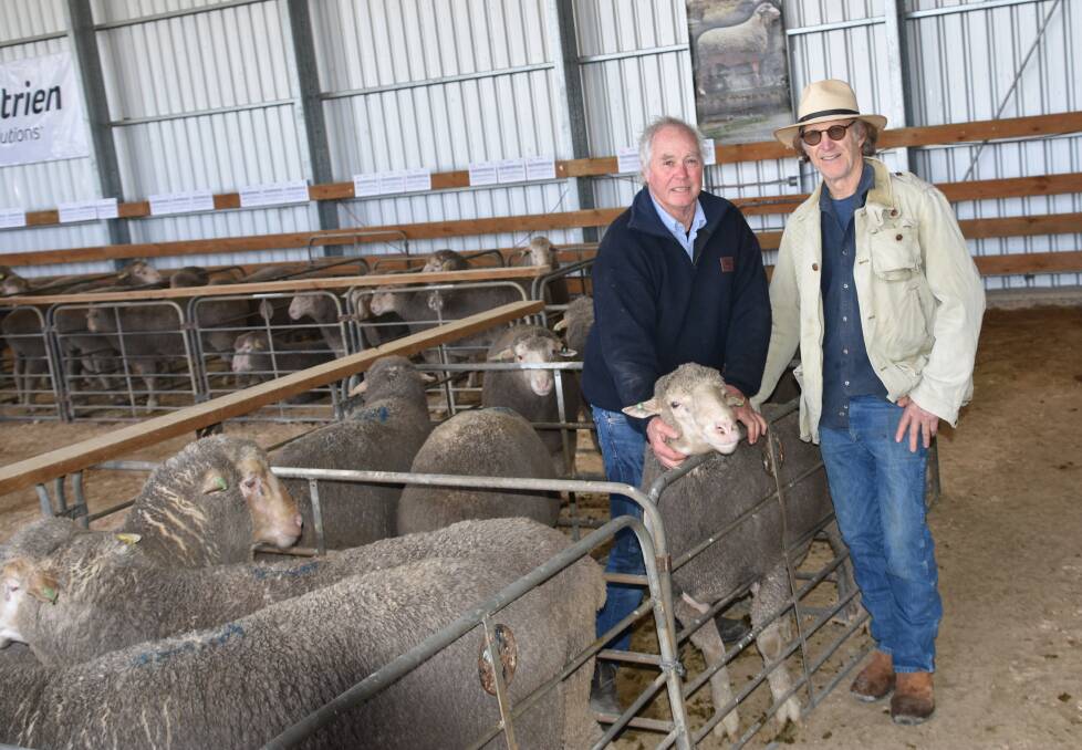 DOING ABILITY: Mt Alma Dohne stud principal Ike Ashby holds the $5000 top price ram with buyer Mitch Harrison, Longwell Station, Broken Hill, NSW.