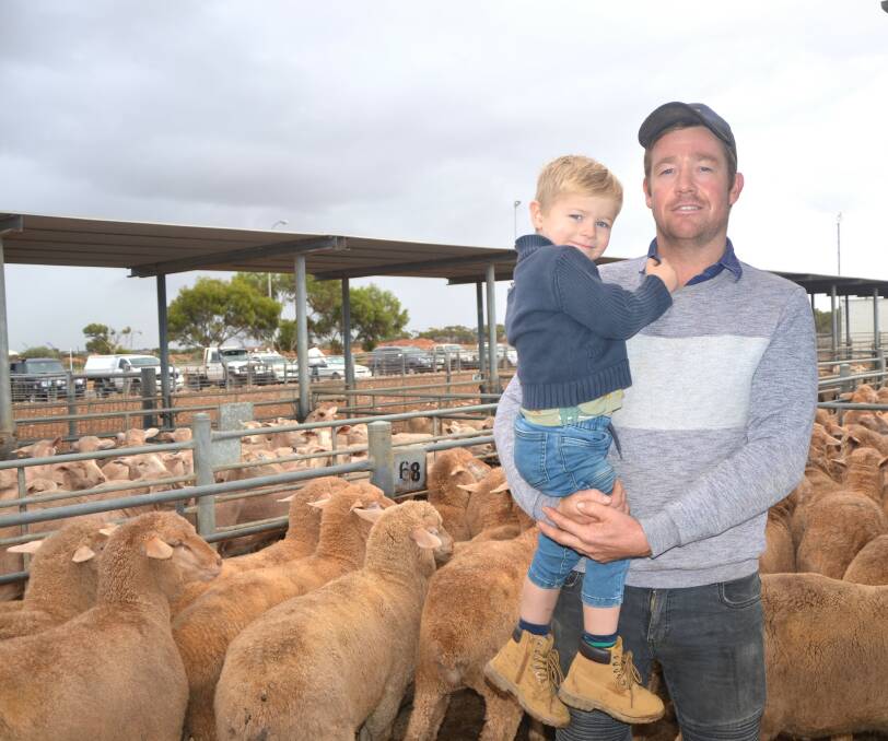 Henry Bennett and his son Darcy with the family's 250 Merino lambs which made $140 at SA Livestock Exchange at Dublin this week. Picture by Vanessa Binks 