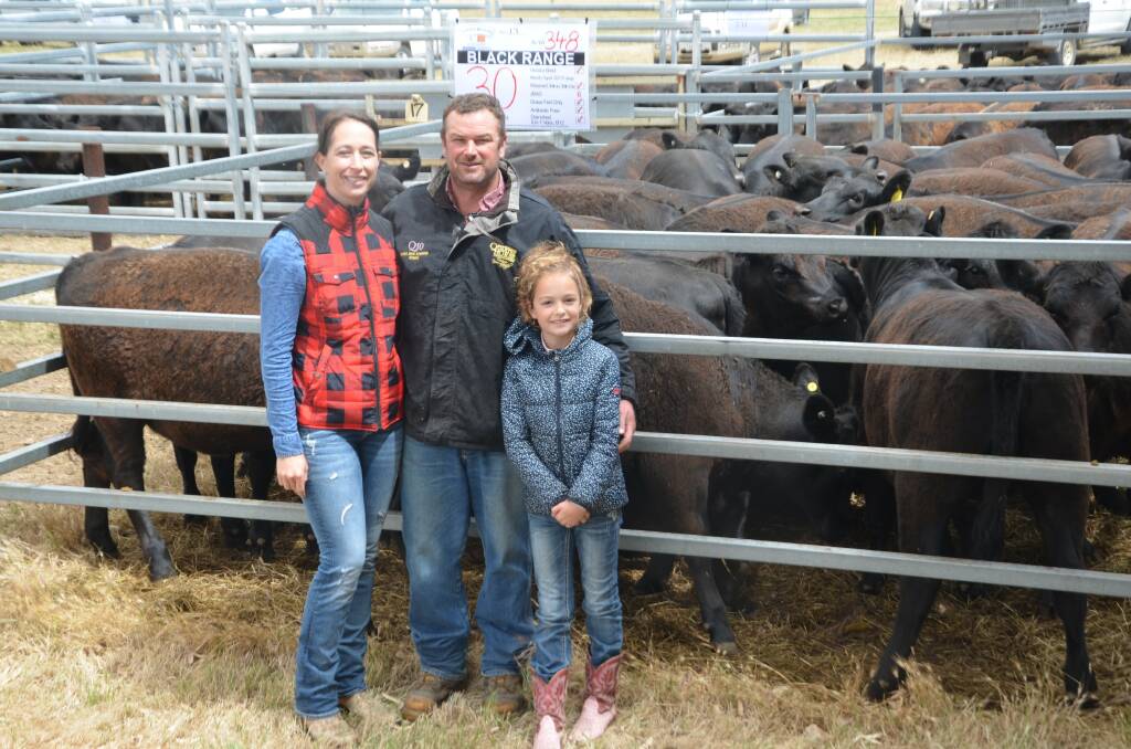 HEAVY HEIFERS: Jaime and Josh Densley with their daughter Scarlett and their $1310 section-topping heifers. 