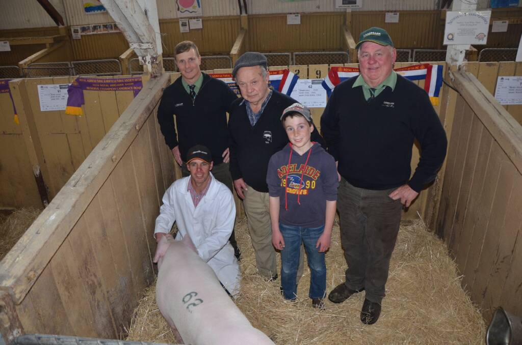 Aroora Enterprises Greg, Jim and Mack Davis, with Landmark Fawcett Mount Pleasant's Ashley Fawcett (back left) and David Schultz (right), and their Landrace boar which sold for $2100.