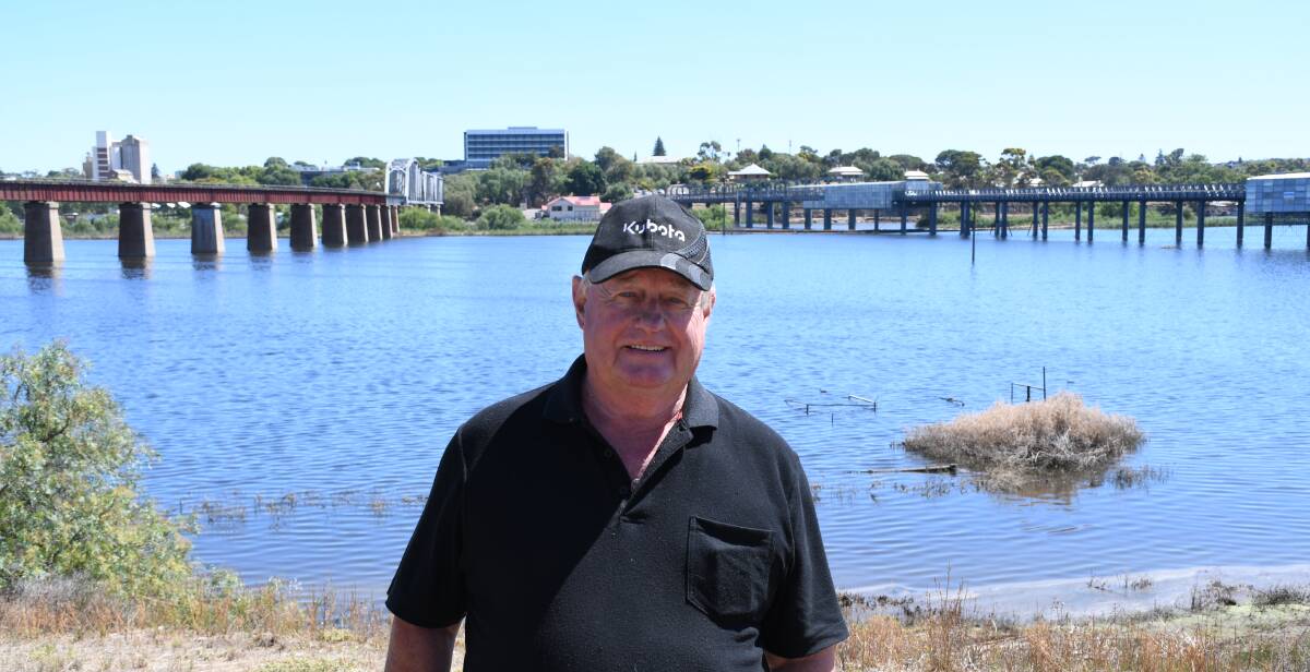 Richard Reedy in front of his flooded grazing flats at Burdett, near the Murray Bridge township. The top rails of his cattle yards are just visible in the background.