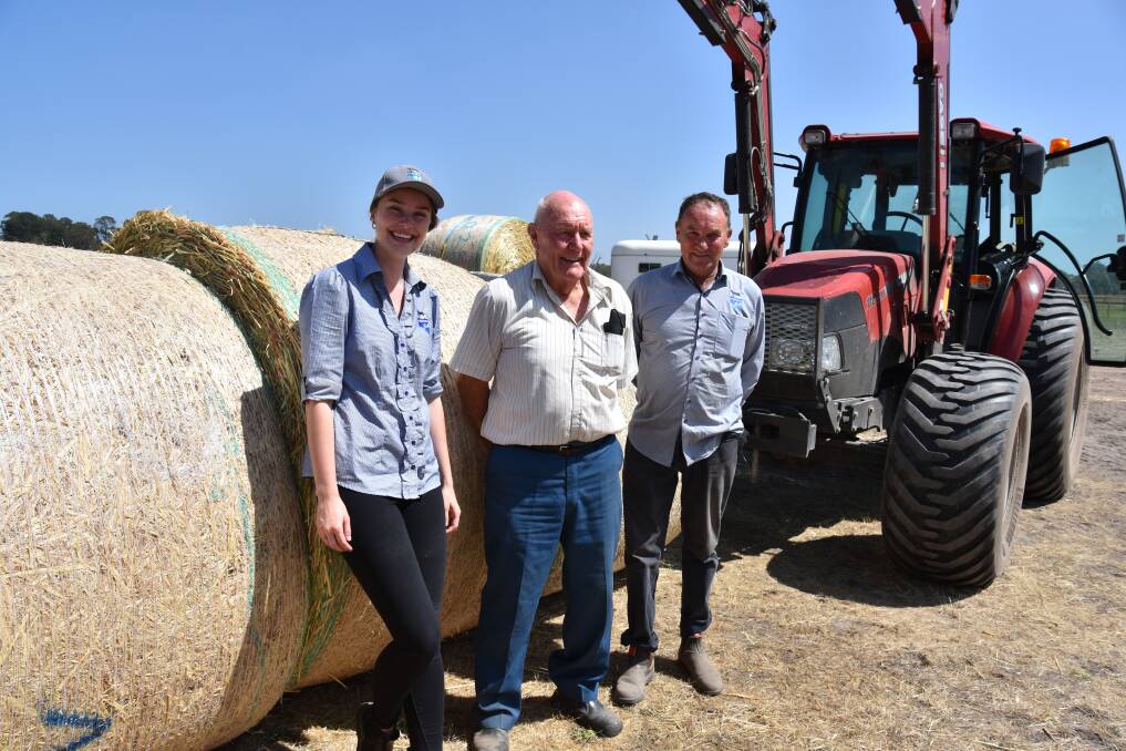 CHIPPING IN: Volunteer Lincoln Woodcock (centre), with Livestock SA's Shannon Logan and Greg Cock at the Oakbank fodder depot, which has received and distributed more than 1000 tonnes of feed since the Cudlee Creek fire.