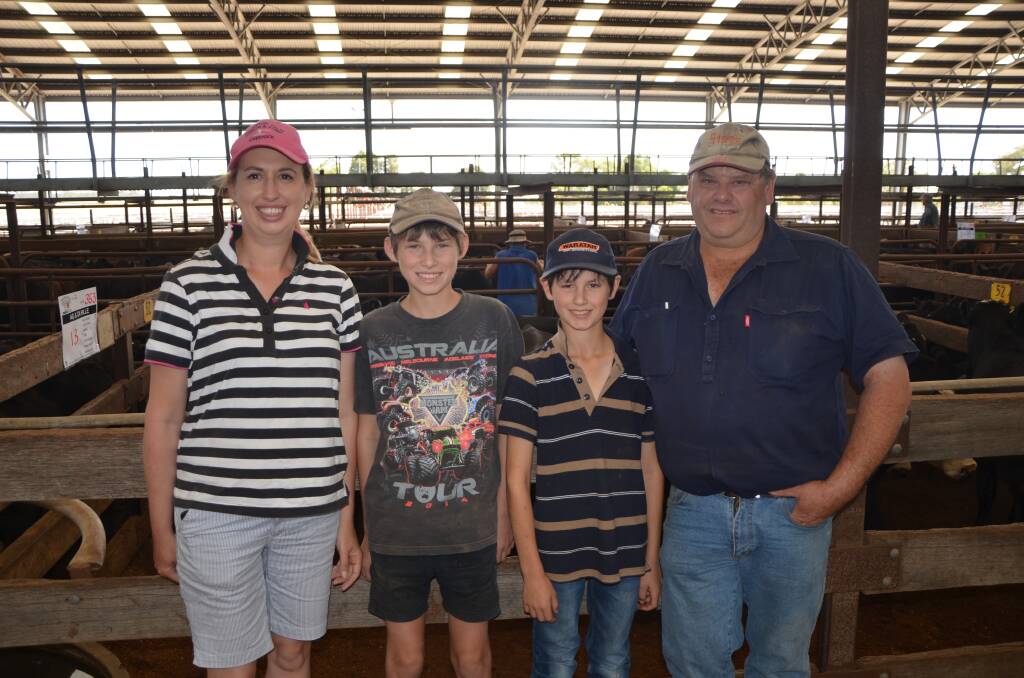 STEER SELLERS: Carol and Anthony Hille, with sons Nicholas and Chris, Conmurra, in front of their pen of 13 March/April 2018-drop Angus steers, av 353kg, which made $1080 or $3.06/kg.