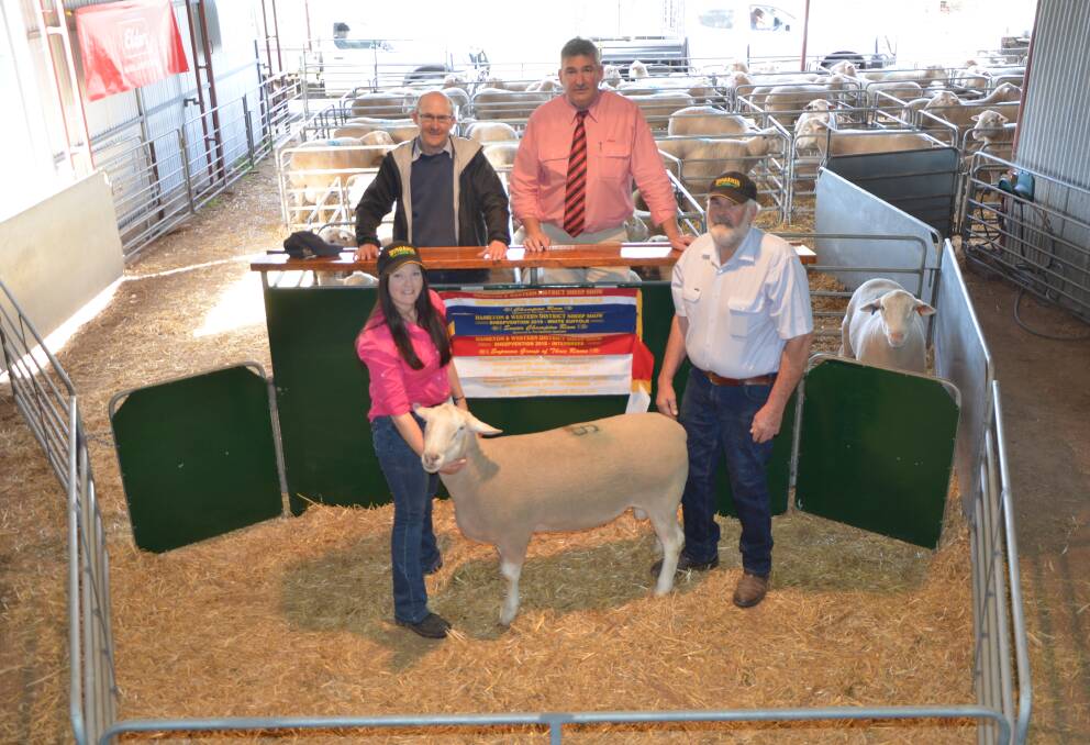 SALE TOPPER: Top price ram buyer Jamie Withers, Nalpa Station, Wellington, and Elders auctioneer Laryn Gogel admire the $2100 White Suffolk, held by Wingamin's Caitlin and Clive Shillabeer.