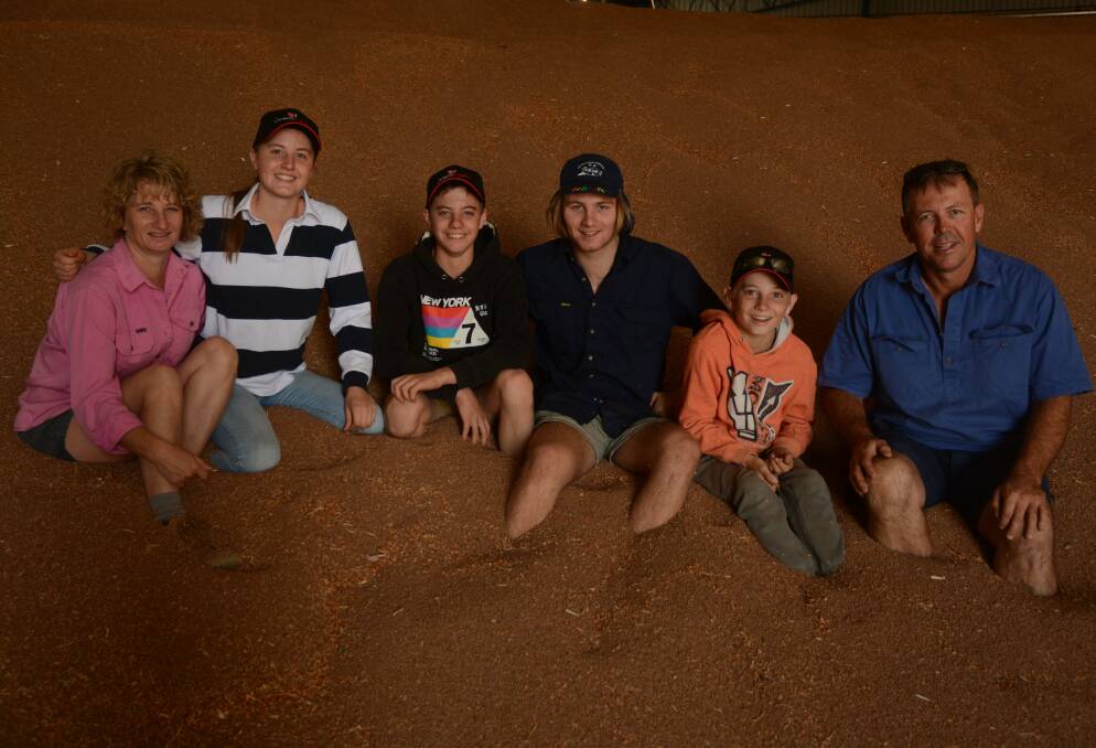 TRACEABLE FOOD: Rosevale Properties owners Anne and Marty (right) Collins, with children Grace, Toby, Henry and Darcy in a stack of their red lentils.