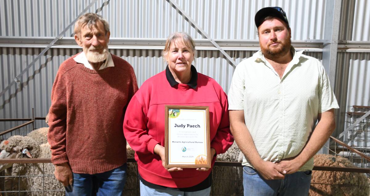 Judy Paech, pictured with husband Keith and Monarto Ag Bureau Lincoln Williss, receives her lifetime service recognition.