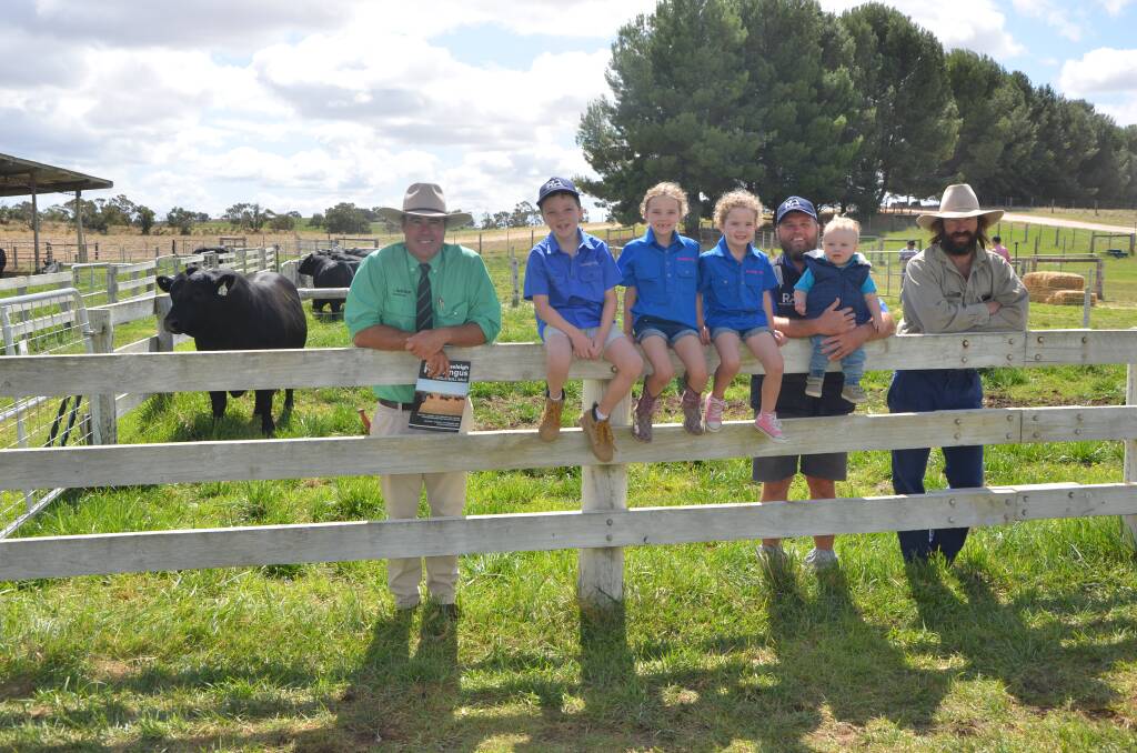 HAPPY DAYS: With the $14,000 top price bull are Nutrien's Richard Miller, Nate, Avie, Mila and Buddy Cowley (held by Roseleigh co-principal Mat Cowley), and top price buyer Nathan Nutt.