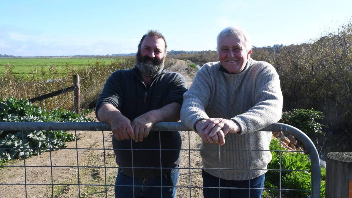 Dairyfarmers Dino Gazzola and Clem Mason on the Jervois levee that was fortified by a band of locals, preventing millions of dollars damage to local farming businesses and the community. Picture by Quinton McCallum