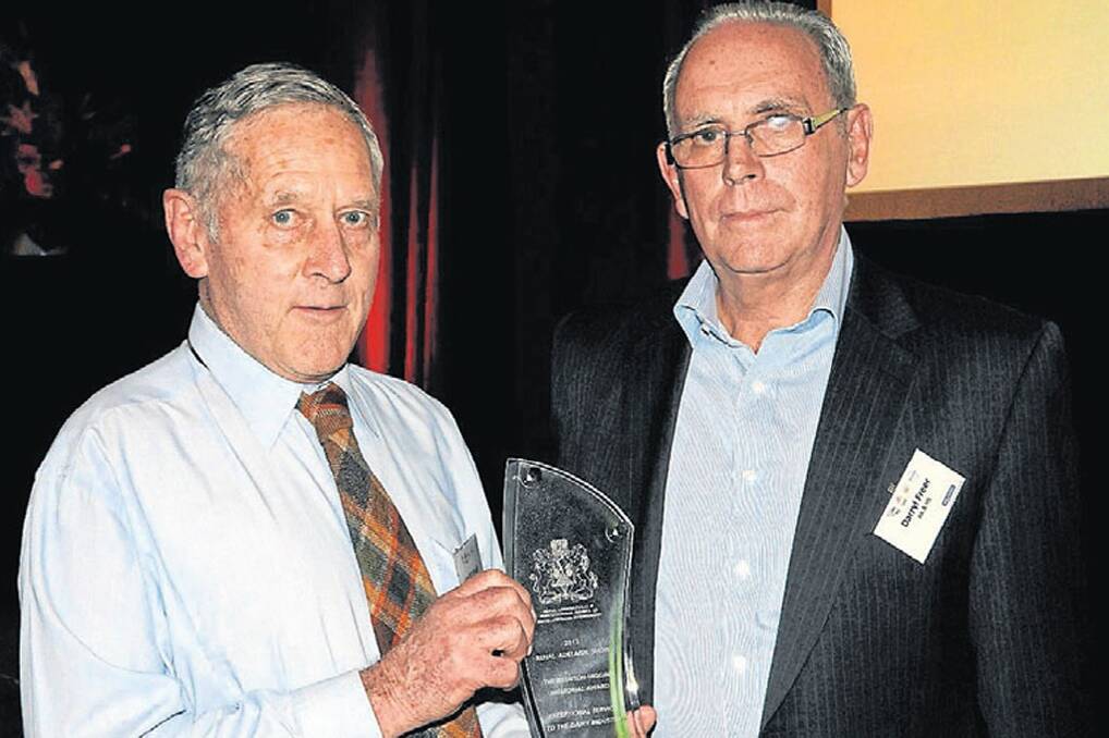 Jim Marshall accepts the Brenton Higgins Memorial Award for outstanding service to the dairy industry, from the Dairy Industry Association of Australia’s Darryl Freer.