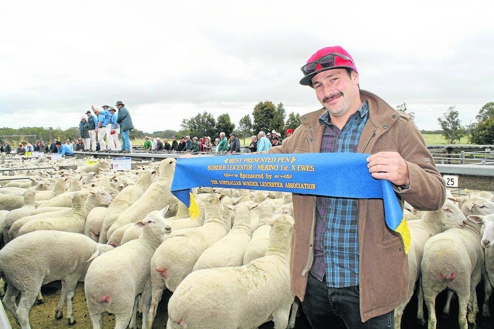 BLUE RIBBON: Duane Simon, McMahon Brothers Pty Ltd, Lameroo, with the ribbon for best-presented pen awarded to his 160 Johnos and Gunallo-sired ewe lambs sold at $196. McMahon Brothers has been selling at the Naracoorte blue ribbon first-cross sale for about eight years and this was the first time they had won the best-presented pen.