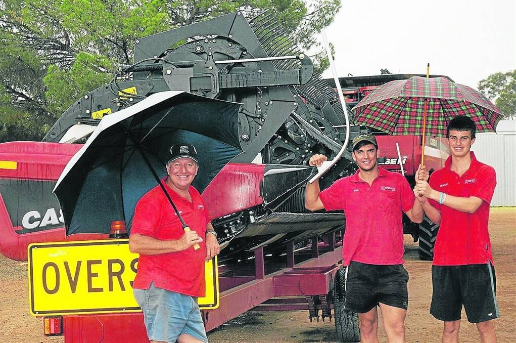 WET FINISH: Mallala farmer Richard Konzag, with son Ryan and his mate Jarrad Dunstan, is all smiles after finishing harvest before the rain hit.