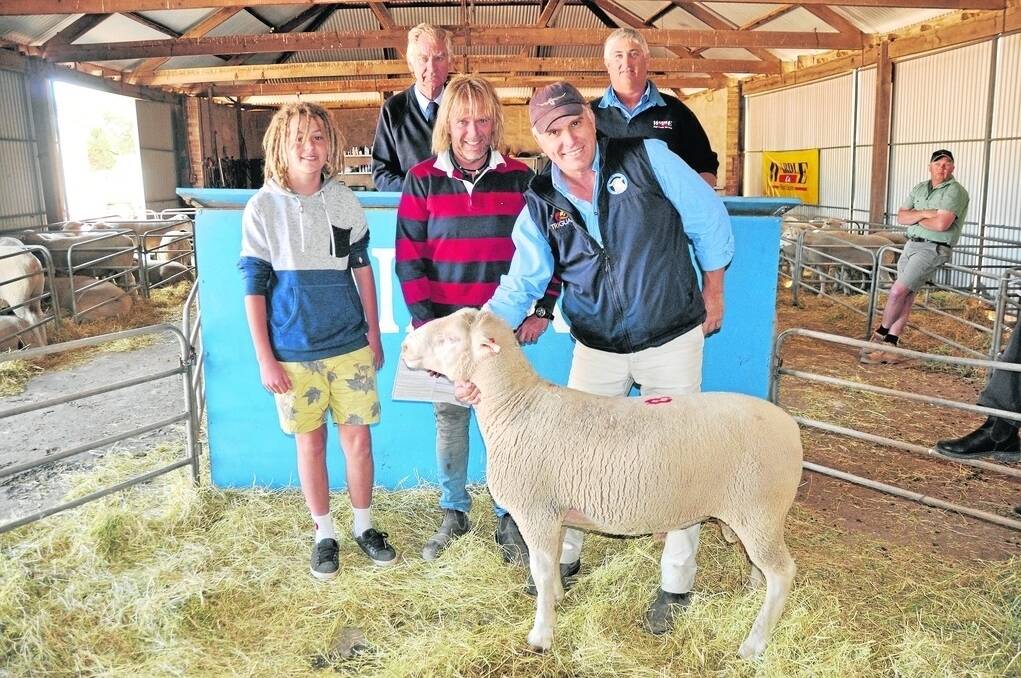 Auctioneer Andrew Butler and Wardle Co’s Tony Clark (back) with top price buyers Koby and Haydn Polgreen, Arthurton, Rilera stud principal David Langford and the top price White Suffolk ram.