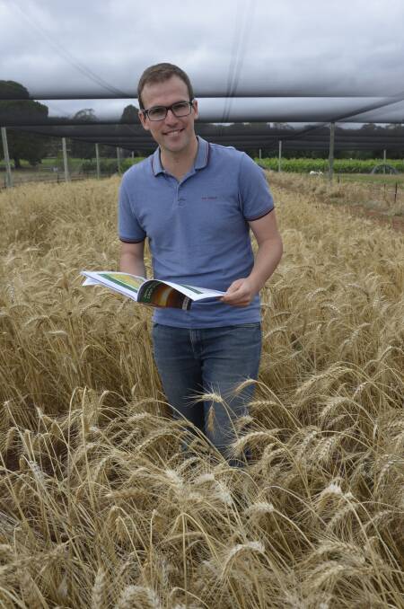 LOOKING AHEAD: SARDI research scientist Kenton Porker at the University of Adelaide's Waite campus with a copy of the SA Crop Sowing Guide.
