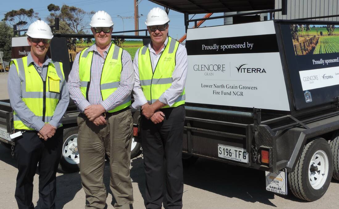 NEW TRAILERS: Viterra operations general manager Tim Krause with BlazeAid volunteer Barry Thompson and Viterra group operations manager Michael Hill.