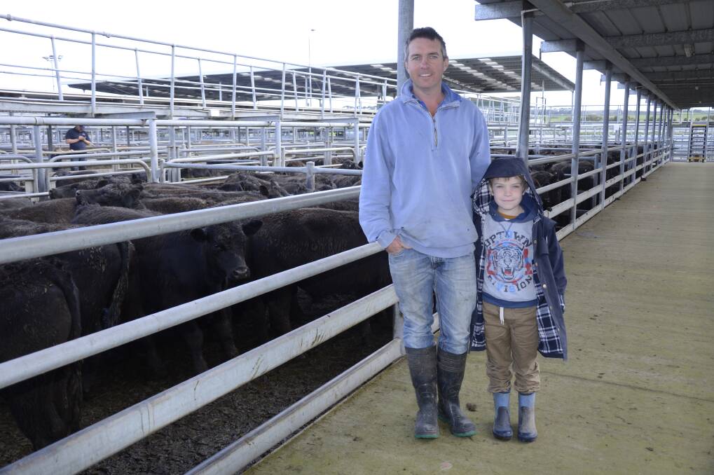 CATTLE CHECK: Sam Thring, Coonawarra, and his son Stuart, 6, check out the cattle at the Mount Gambier store sale on Friday.