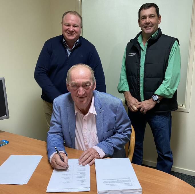 Signing the sale contracts - Wally Taylor, Parkdale, Goondiwindi, with Clayton Smith, JLL Agribusiness, and Andrew Jakins, Nutrien Harcourts.