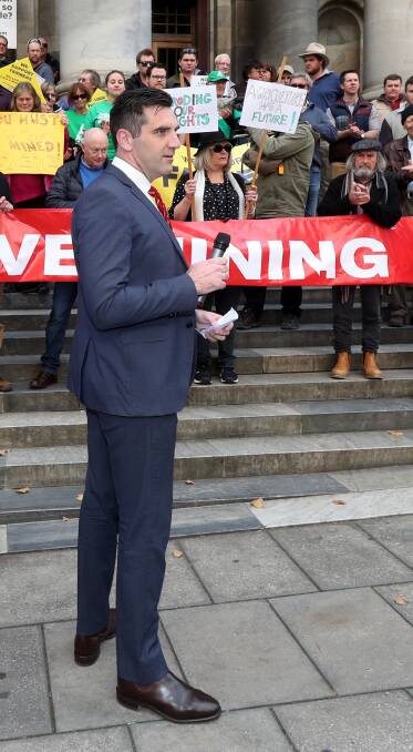 Fraser Ellis prepares to address a rally on the steps of Parliament House on Wednesday. Photo: AAP/KELLY BARNES