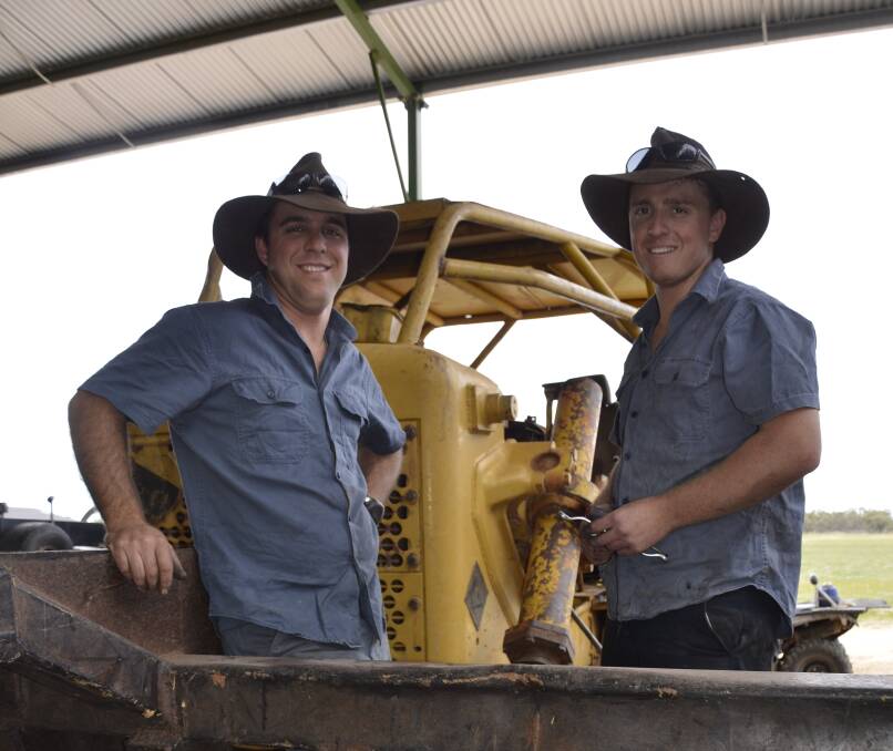 ENSURING VIABILITY: Tom and Sam Barnes with the land clearer used to open up valuable cropping land.